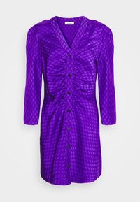 Lila klänning med trekvartsärmar, som har ett texturerat mönster och knappar fram. Inkluderar rynkade detaljer längs torso.