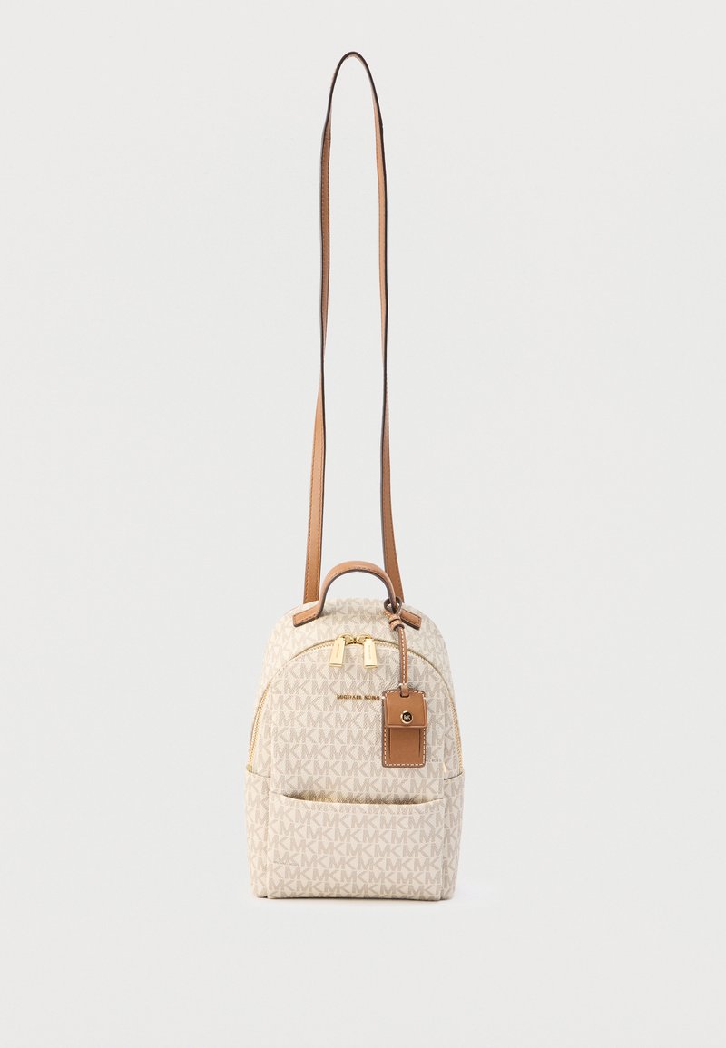 Petit sac bandoulière beige avec motif logo MK, poche zippée à l'avant, accents en cuir marron, tirettes de fermeture éclair dorées et étiquette attachée.