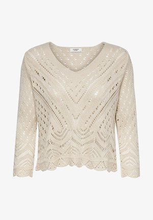 Pulôver de malha na cor creme, com decote em V, mangas três quartos e barra com bordado. Apresenta um padrão de trabalho em aberto com designs em zigue-zague e ovais.