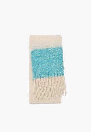 Miękki koc z mieszanki wełny w kolorze kremowym z gradientowym niebieskim paskiem i frędzlami po jednym końcu. Teksturowane wykończenie zwiększa atrakcyjność wizualną.