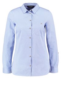 Ljusblå långärmad skjorta med knappar i bomull, med krage, en bröstficka och silverfärgade knappar längs framsidan.