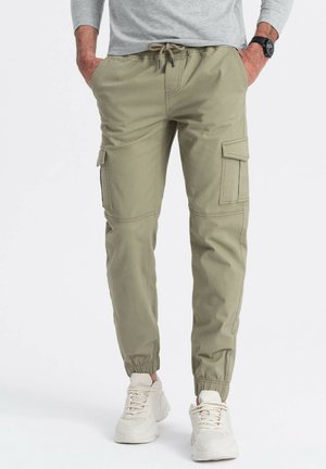 Helle grüne Cargo-Hose mit elastischen Knöchelbündchen, Kordelzug in der Taille und zwei Seitentaschen. Hergestellt aus strapazierfähigem Stoff mit glatter Textur.
