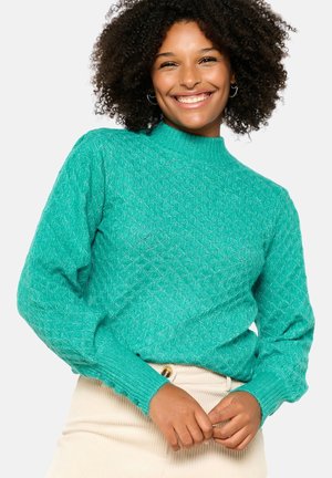 Turquoise knitted sweater with diamond pattern, high neck, and long sleeves featuring ribbed cuffs. Soft texture and lightweight material.