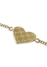 Ciondolo a forma di cuore in oro con un motivo a griglia texturizzata e punti in rilievo, attaccato a una catena. La superficie è lucida e liscia.
