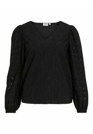 Sort top med V-udskæring, tekstureret stof med diamantmønster og lange puff ærmer, samlet ved manchetterne.