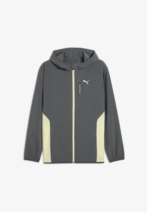 Dunkelgraue Kapuzenjacke mit Reißverschluss, hellbeigen Seitenteilen, elastischen Bündchen, einer Reißverschlusstasche auf der Brust und einem weißen Puma-Logo auf der Brust.