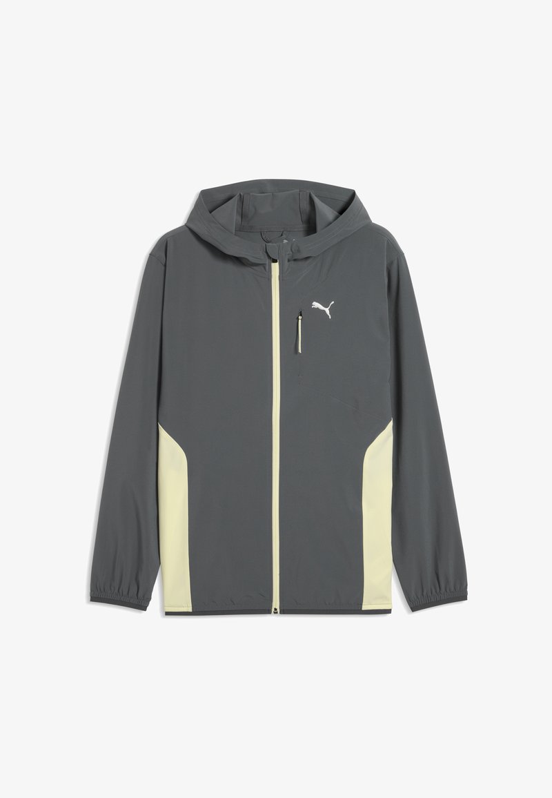 Veste à capuche zippée gris foncé avec panneaux latéraux beige clair, poignets élastiques, poche zippée sur la poitrine et logo Puma blanc sur la poitrine.