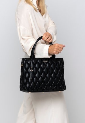 Black quilted handbag made of glossy leather, featuring a structured shape, dual handles, and gold-tone hardware accents.