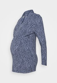 Camisa de maternidade em azul-marinho com padrão de pontos abstratos em azul-claro, apresentando um decote em V, mangas longas e detalhes franzidos na cintura.