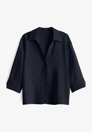 Camicia blu navy con bottoni, dalla superficie testurizzata, maniche corte e colletto classico. Presenta sei bottoni abbinati lungo la parte anteriore.