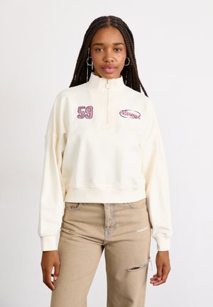 Cream zip-up sweatshirt with embroidered "59" and brand logo. Features long sleeves and a cropped design with a soft texture.