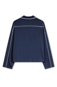 Navy long-sleeve polo shirt with a ribbed collar, white accent piping along the shoulders and back, soft cotton fabric.