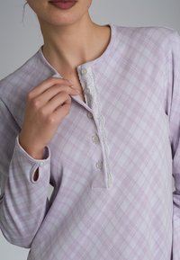 Top a maniche lunghe a quadri lavanda realizzato in morbido tessuto, con placca a bottoni, bordo in pizzo e polsini bottonati con asole per una vestibilità sicura.