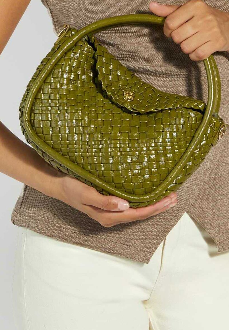 Woven green handbag with a rounded shape and glossy finish. Features a curved handle and a flap closure with a decorative hardware detail.