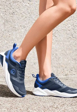 Navy and blue athletic shoes with mesh upper, textured panels, and white sole. Lightweight design, featuring laces and back pull tab for easy wear.