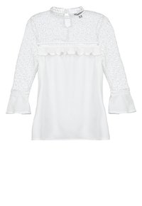 Blusa bianca con maniche lunghe, decorata con pizzo, scollo rotondo, orlo a volant in vita e polsini delle maniche a campana.