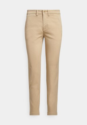 Beige bomulls-chinos med rak passform, utrustade med knappstängning, framfickor och sydda detaljer längs sömmarna.