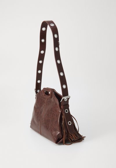Brown leather handbag with a textured finish, featuring a fringe detail and a contrasting strap with circular metal accents.