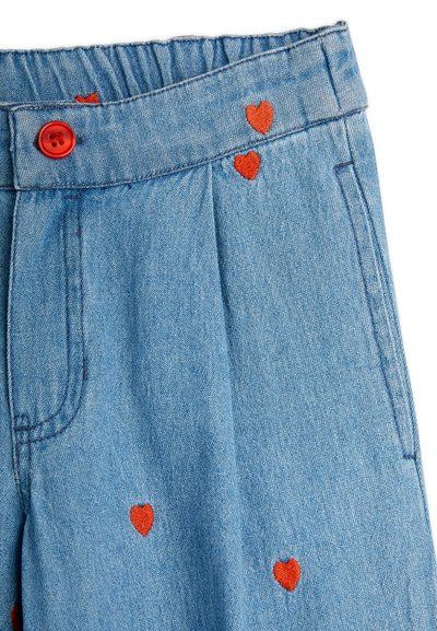 Denim pants with an elastic waistband, light blue color, featuring red heart-shaped embroidery and a red button detail above the waist.