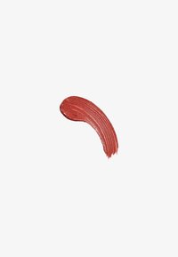 Creamy lip color swatch in a muted red shade with a smooth texture and subtle sheen, applied in a curved stroke on a white background.