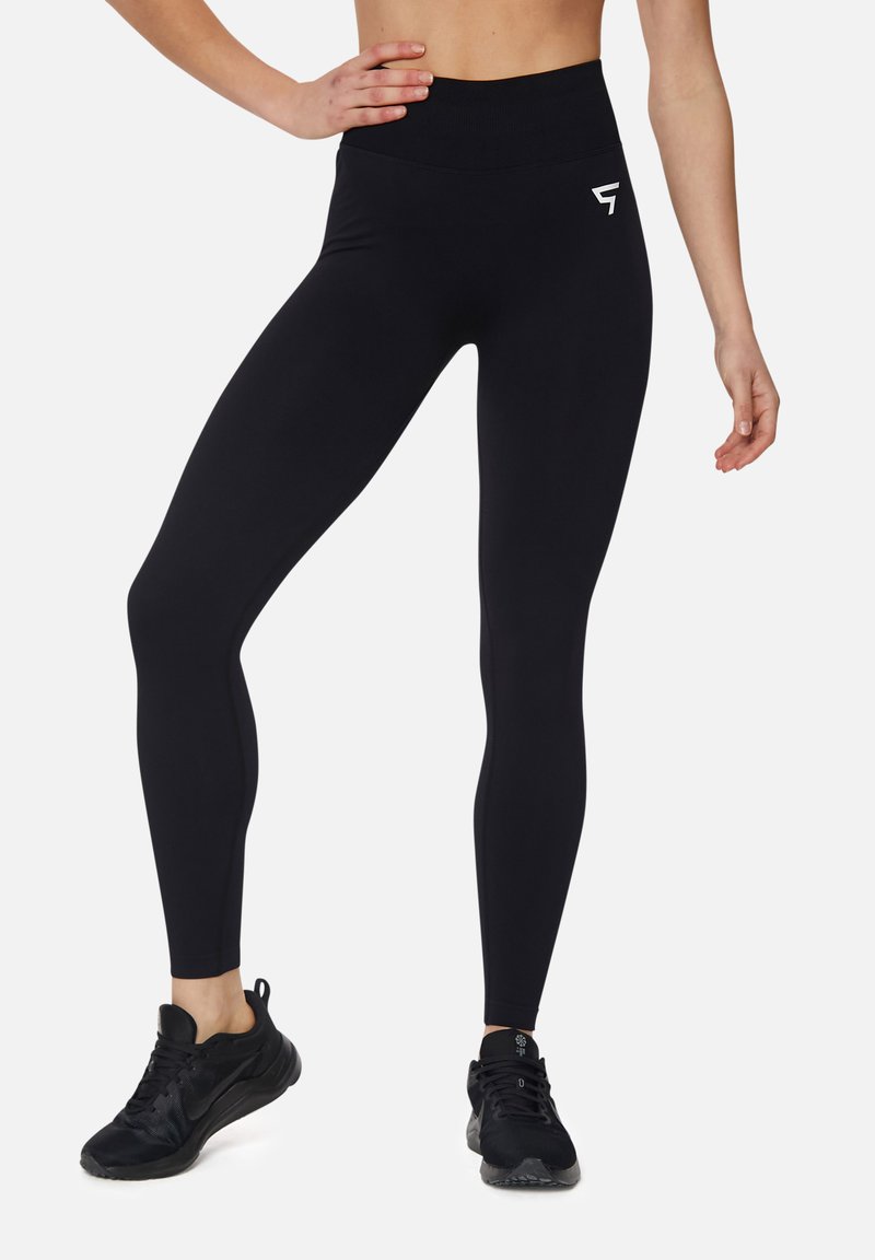 Black leggings with a high waistband, smooth texture, featuring a small white logo on the left hip. Suitable for active wear.