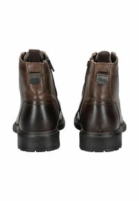 Botas de tobillo de cuero marrón con un acabado suave, cierre de cremallera y forro texturizado, con una suela de goma negra y un acento del logo de Jeep.