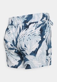 Modré a bílé květinové šortky se zakončením na gumu a detailem vázání, vyrobené z lehkého materiálu s hladkou texturou.