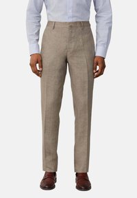 Beige linen trousers with a tailored fit, featuring a flat front and crease lines, paired with dark brown leather shoes.