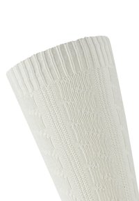 Weißer gestrickter Socken mit geripptem Bund und strukturiertem Muster. Der Stoff wirkt weich und zeigt ein diamantähnliches Design entlang des Schaftes.