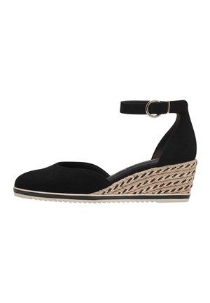 Black suede wedge shoe with ankle strap, featuring a braided jute heel and a textured rubber sole for grip. Rounded toe design.