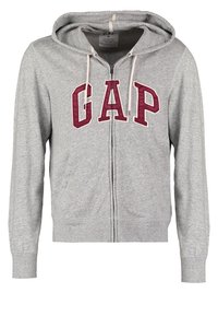 Felpa grigia con zip, realizzata in un morbido misto cotone, con un grande logo "GAP" color bordeaux e cappuccio con cordino. Include tasche frontali e polsini a costine.