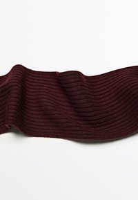 Burgundy ribbed knit fabric with a soft texture, flowing in waves. The pattern features horizontal ridges, creating visual depth.