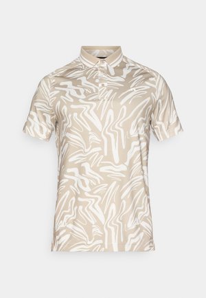 Beige polo shirt featuring a white abstract pattern, constructed from smooth fabric with a standard collar and three buttons.