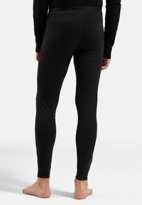 Black, stretchy leggings with a fitted design, featuring a comfortable waistband and ribbed cuffs, made from smooth, lightweight material.