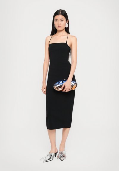 Black, fitted midi dress with thin straps and a straight neckline. Paired with metallic silver mules and a shiny blue and gold clutch.
