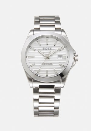 Silver stainless steel watch with a textured white dial, silver hour markers, date display, and a metal link bracelet. Water-resistant to 50 meters.