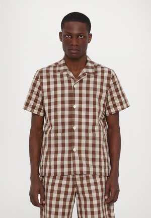 Short-sleeve brown and white plaid shirt with a collar, front buttons, and two front pockets; made of lightweight fabric.