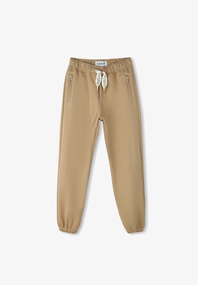 Beige joggings met een elastische tailleband, trektouw en twee ritszakken aan de zijkant. Gemaakt van een soepele, stretchy stof.