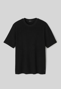 T-shirt noir à manches courtes et col rond, en maille côtelée. Texture douce, ourlet droit et petit logo sur le côté inférieur. Design minimaliste.