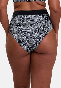 Bas de bikini taille haute noir avec motif de feuilles tropicales blanches ; tissu lisse ; taille élastique ; design couvrant.