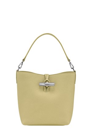 Green textured leather handbag with a silver toggle closure, a short handle, and a minimalist, rounded shape.