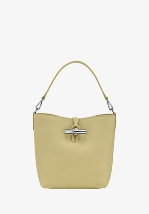Green textured leather handbag with a silver toggle closure, a short handle, and a minimalist, rounded shape.