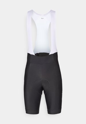 Cuissards de cyclisme noirs avec un dos en maille lilas clair, dotés d'un rembourrage au niveau de l'assise et d'ouvertures de jambes sans couture pour assurer confort et soutien.