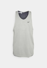 Light gray athletic tank top with a round neckline, sleeveless design, and a small black Nike logo. Interior features a black and white dotted pattern.