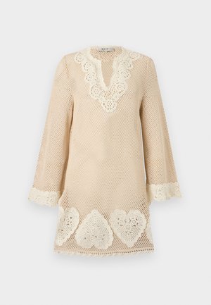Beige crochet dress with long sleeves, scalloped V-neckline, and white lace heart patterns along hem and cuffs.