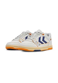 White sneakers with navy blue and orange accents. Features a smooth leather upper, textured tongue, and patterned rubber sole.
