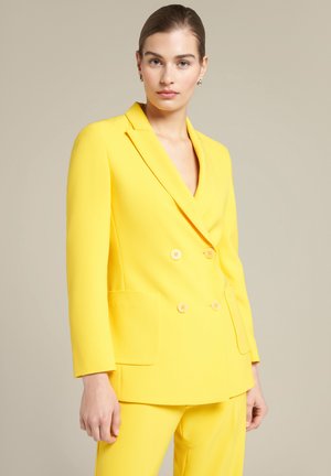 Double-breasted yellow blazer in smooth fabric, featuring two front pockets, notched lapels, and light buttons. Tailored fit.