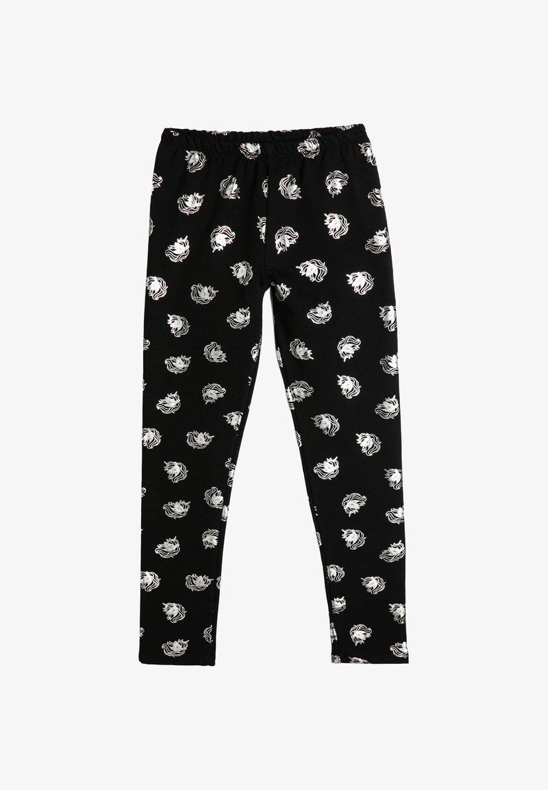 Leggings negros hechos de una tela suave con un patrón repetido de cabezas de león blancas, cinturilla elástica y un diseño ceñido.