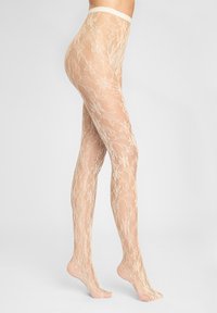 Rajstopy bezuciskowe w kolorze cielistym z koronkowym wzorem, przezroczystą fakturą oraz elastyczną talią, z kwiatowymi wzorami na całej powierzchni i otwartym palcem.