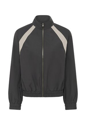 Veste noire zippée avec poignets et ourlet élastiqués, ornée de rayures diagonales beige clair sur les épaules.